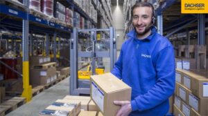 Dachser employee in warehouse holding package